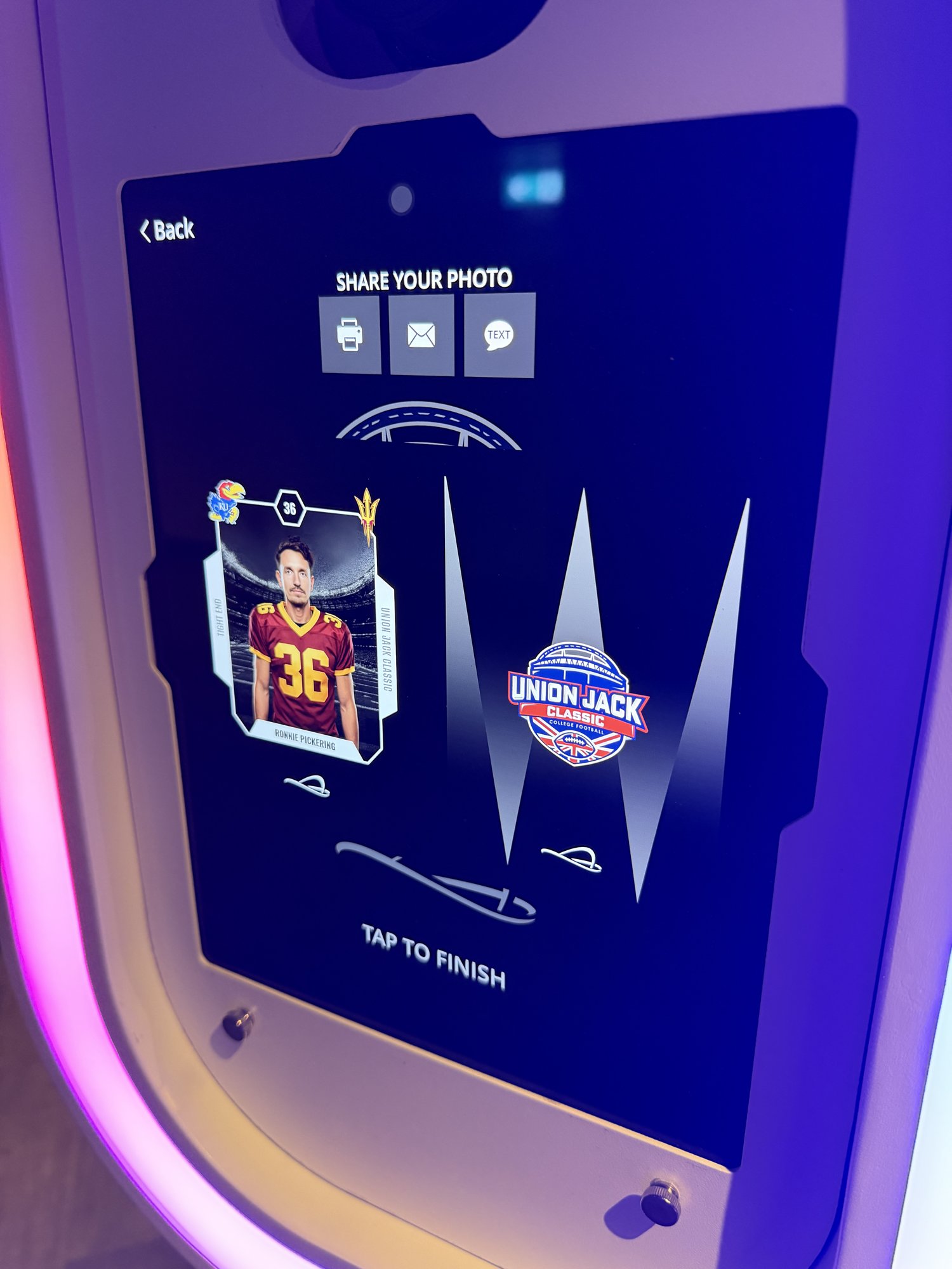 AI photo booth screen showing a finished Union Jack Classic trading card with print, email and text sharing options