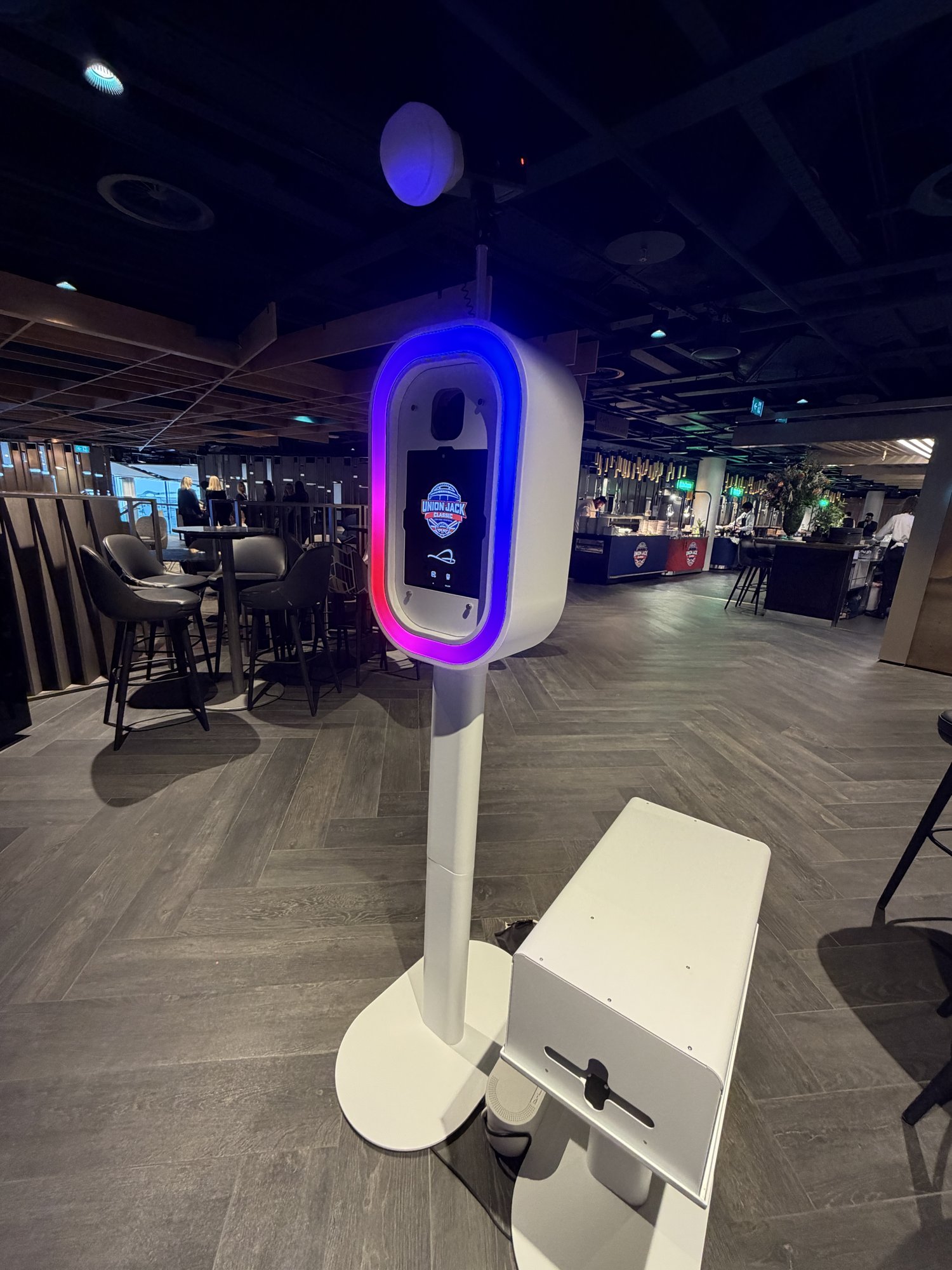 Branded AI photo booth set up in the Club Wembley hospitality area for the Union Jack Classic college football game