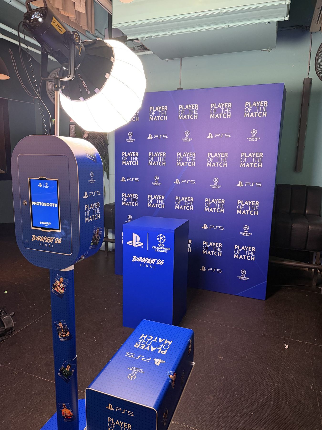 Blue PlayStation branded photo booth beside a Player of the Match plinth and step and repeat backdrop, Champions League Final, Budapest